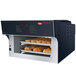 A Hatco Flav-R-Savor pass-through heated air curtain holding several trays of bread in a bakery display.