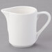 A Tuxton white china creamer pitcher with a handle.