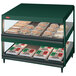 A Hunter green Hatco countertop display case with food on slanted shelves.