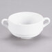 A close-up of a Tuxton AlumaTux Pearl White soup cup with two handles.