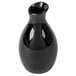 A close-up of a black American Metalcraft ceramic jug vase.