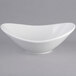 A Tuxton bright white china bowl with a curved edge.