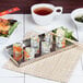 A plate of sushi on an American Metalcraft hammered stainless steel tray with chopsticks.