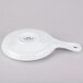 A bright white ceramic skillet with a handle.
