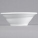 A close-up of a Tuxton Linx bright white china bowl with a small spiral rim.
