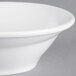 A close-up of a Tuxton bright white china bowl with a spiral pattern inside.