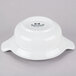 A Tuxton bright white china casserole dish with 2 lug handles and black text on it.