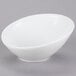 A Tuxton TuxTrendz Linx white china bowl with a slanted rim on a gray surface.