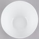 A Tuxton TuxTrendz bright white china bowl with a slanted edge on a gray surface.