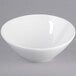 A Tuxton bright white china bowl with a small slanted rim.