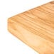 An American Metalcraft olive wood serving board on a wood surface.