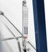 A thermometer on a metal shelf inside a Hatco stainless steel countertop food warmer.