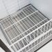 A close-up of a white metal rack inside a white Turbo Air ice merchandiser.