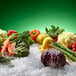 A group of vegetables on flake ice with a white background.