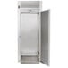 A Traulsen stainless steel roll-in freezer with a stainless steel door and silver handle.