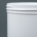 A close-up of a white plastic container with a lid.