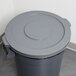 A grey plastic Continental lid for a 20 gallon round trash can.