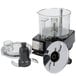 A clear Waring commercial food processor with a clear lid.