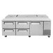 A Turbo Air stainless steel pizza prep table with 4 drawers.