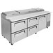 A Turbo Air stainless steel pizza prep table with 4 drawers.
