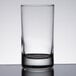 A close-up of a Libbey juice glass on a table with a white background.