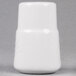 A white ceramic pepper shaker with a lid.
