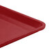 A close-up of a Cambro cherry red dietary tray with a plastic handle.