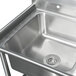 An Advance Tabco stainless steel three compartment corner sink with two drainboards.