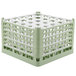 A light green Vollrath glass rack with 25 compartments.