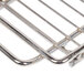 A metal charcoal grill grate with handles.