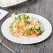 A Tuxton AlumaTux Pearl White china plate with a salad of carrots and cabbage on it.