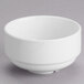 A Tuxton AlumaTux Pearl White stackable soup cup without a handle on a gray surface.