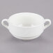 A close up of a Tuxton AlumaTux Pearl White soup cup with two handles.