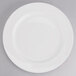 A Tuxton AlumaTux Pearl White china plate with a circular edge on a white background.