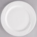 A Tuxton AlumaTux Pearl White china plate with a curved edge on a white background.