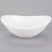 A Tuxton white china bowl with a curved edge on a white background.