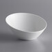 A Tuxton AlumaTux Pearl White slant china bowl on a gray surface.