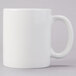 A Tuxton AlumaTux Pearl White china mug with a white handle.