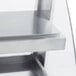 A close up of a white metal shelf with two shelves on it.