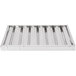 An aluminum hood filter with ridged baffles in a silver metal tray.
