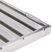 An aluminum hood filter with ridged baffles in a white background.