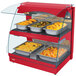 A red Hatco countertop double shelf food warmer with food on display.