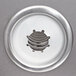 A circular silver metal plate with a small hole in the middle.