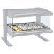 A Hatco white granite heated zone merchandiser with food on a silver tray in it.