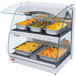 A white Hatco countertop food warmer with double shelves holding trays of food on display.