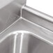 A close-up of a stainless steel Advance Tabco three compartment pot sink with two drains.