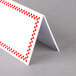A white rectangular card with a red checkered border.