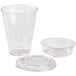 A clear plastic cup with a flat lid and a plastic container.