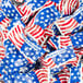 A pile of red, white, and blue American flag candy wrappers.