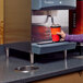 A person using a Follett 4" leg kit to install a coffee machine.